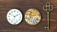 Vintage ornate key, clock face and watch mechanism, escape room, time concept